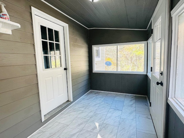 unfurnished sunroom with wood ceiling