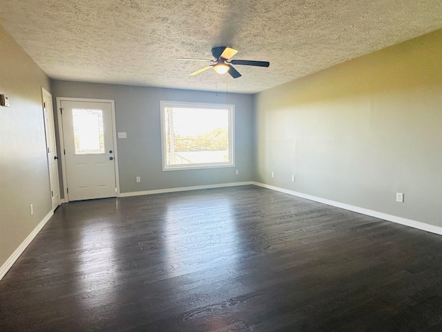 spare room with ceiling fan, dark hardwood / wood-style flooring, and a textured ceiling