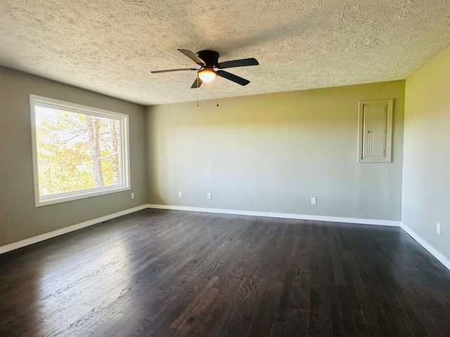 spare room featuring ceiling fan, dark hardwood / wood-style flooring, and a textured ceiling