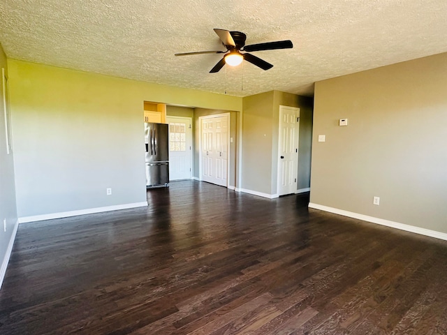 spare room featuring a textured ceiling, ceiling fan, and dark hardwood / wood-style floors