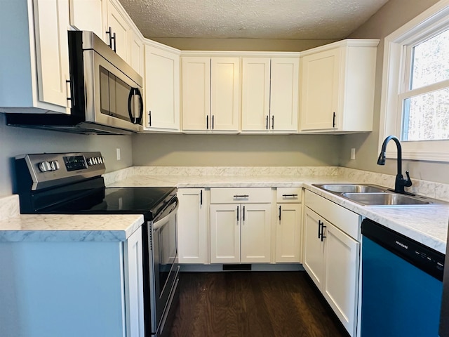 kitchen featuring white cabinetry, sink, dark hardwood / wood-style floors, a textured ceiling, and appliances with stainless steel finishes