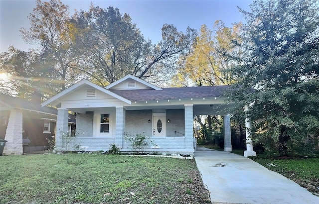 view of front facade with a carport and a front yard