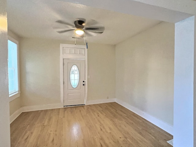 entrance foyer with ceiling fan and light wood-type flooring