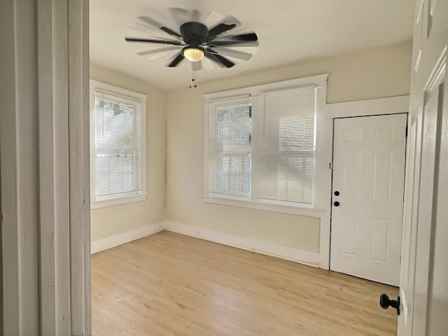 foyer entrance featuring ceiling fan and light wood-type flooring