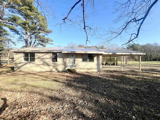 rear view of house with a yard and a carport