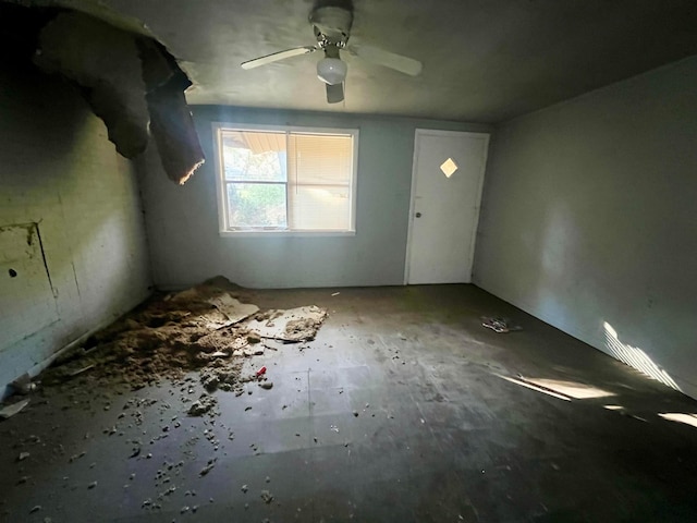 interior space with ceiling fan