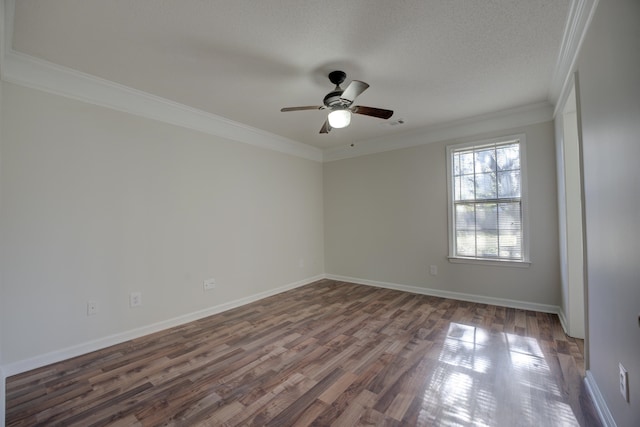 spare room with ornamental molding, a textured ceiling, ceiling fan, and dark wood-type flooring