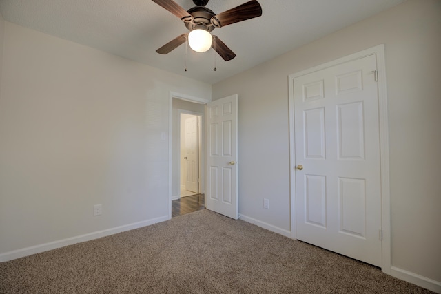 unfurnished bedroom with carpet flooring and ceiling fan