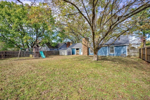 view of yard with a playground and a shed