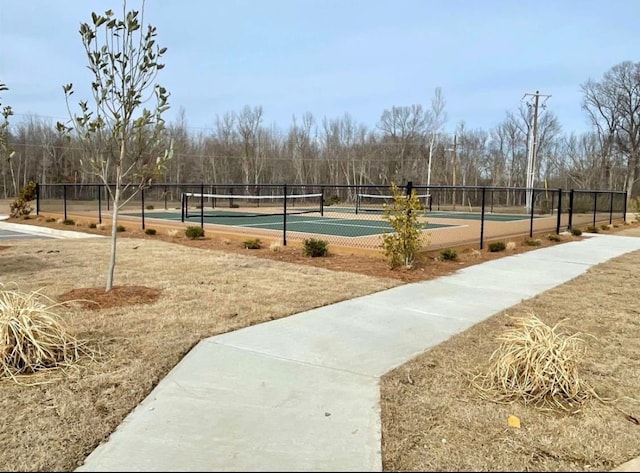 view of community featuring tennis court