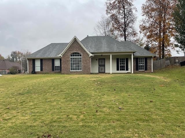 ranch-style home featuring a front yard