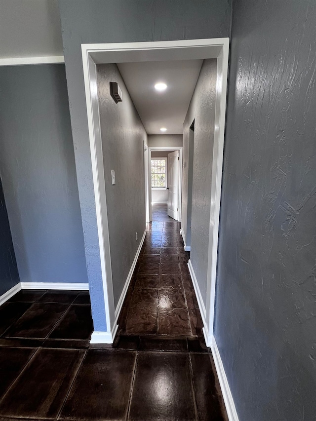 corridor with dark tile patterned flooring