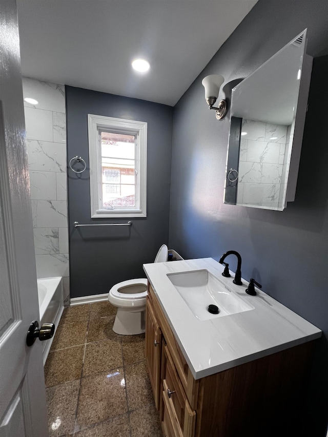 full bathroom with vanity, toilet, and tiled shower / bath combo