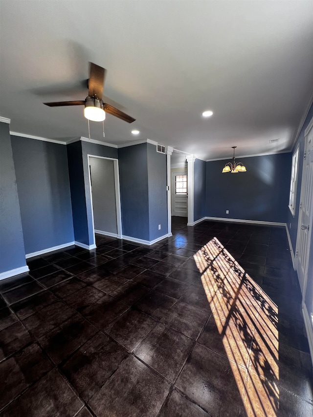 unfurnished room featuring ceiling fan with notable chandelier, ornate columns, and crown molding