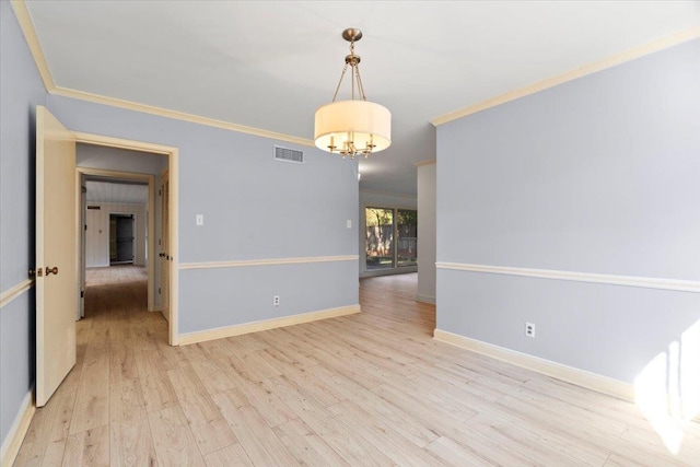 empty room with light wood-type flooring, crown molding, and an inviting chandelier