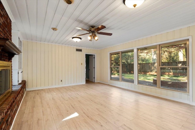 unfurnished living room with ceiling fan, plenty of natural light, and light wood-type flooring