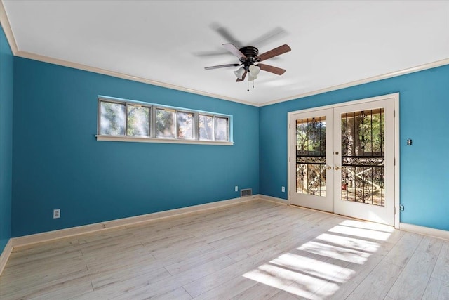 empty room featuring light hardwood / wood-style flooring, a wealth of natural light, and french doors