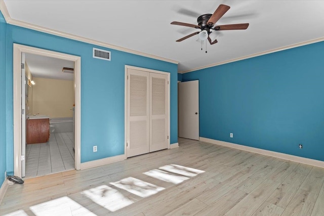 unfurnished bedroom with ceiling fan, a closet, crown molding, and light wood-type flooring