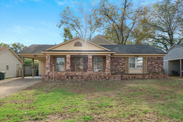 view of front of house with a carport and a front lawn