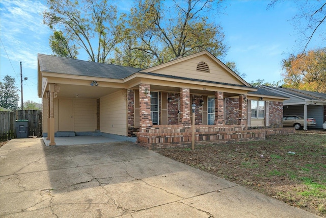 ranch-style house with a carport and a porch