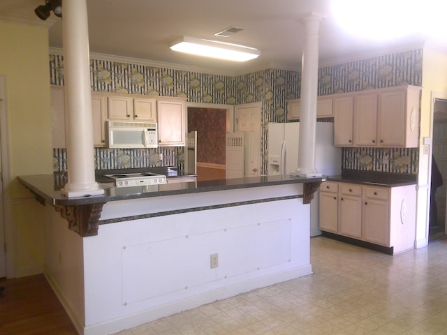 kitchen featuring ornate columns, kitchen peninsula, crown molding, white appliances, and decorative backsplash