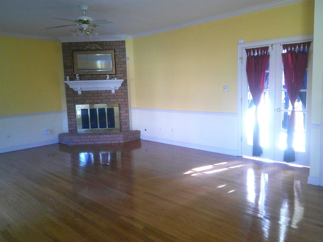 unfurnished living room featuring crown molding, ceiling fan, and dark wood-type flooring