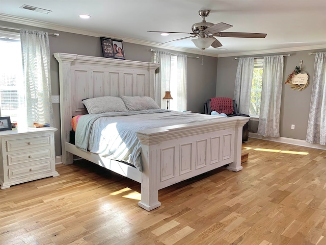 bedroom with ceiling fan, light hardwood / wood-style floors, and crown molding