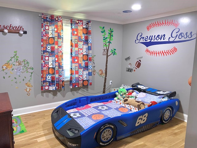 bedroom featuring hardwood / wood-style floors and ornamental molding