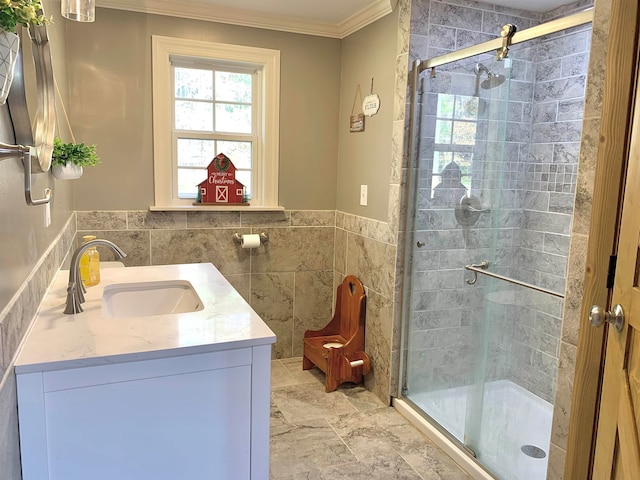 bathroom with a shower with shower door, ornamental molding, and vanity