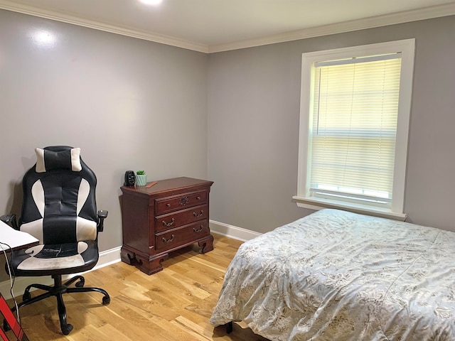 bedroom with ornamental molding and light wood-type flooring