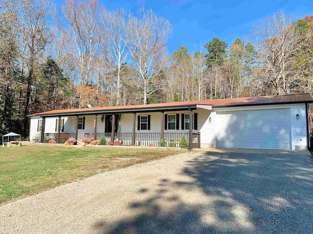 view of front facade with a porch, a garage, and a front lawn