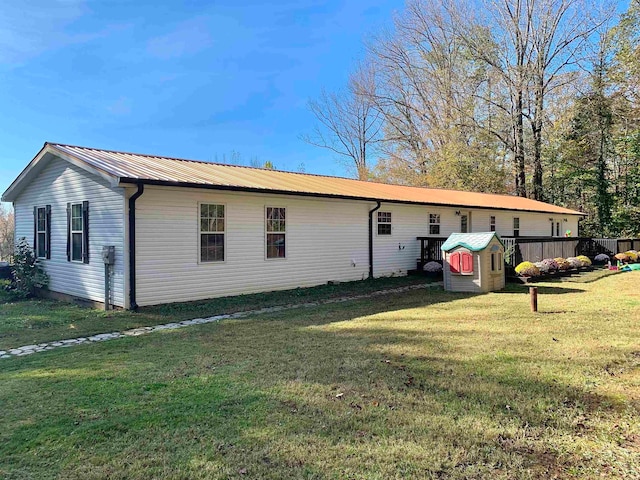 rear view of house with a lawn