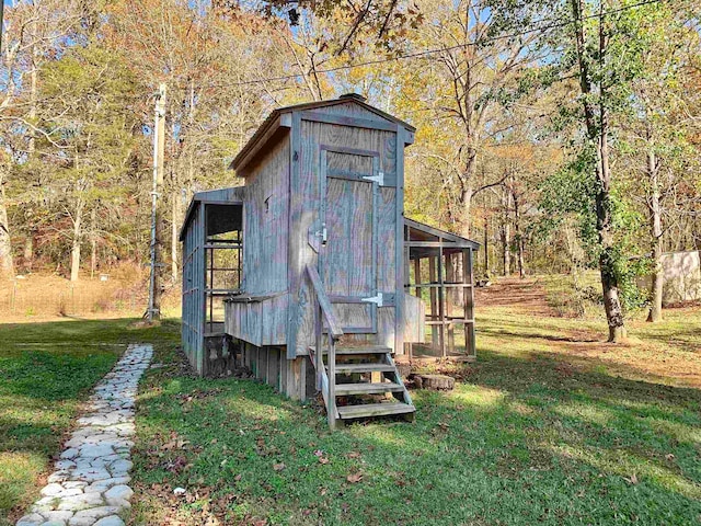 view of outbuilding featuring a lawn