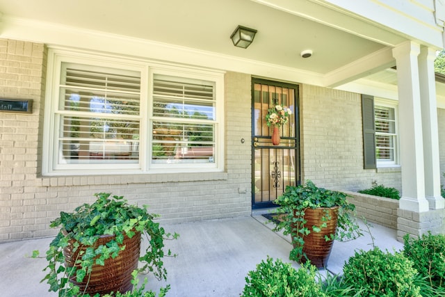 view of exterior entry featuring a porch