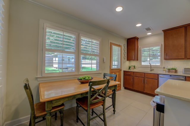 kitchen featuring backsplash, dishwasher, plenty of natural light, and sink