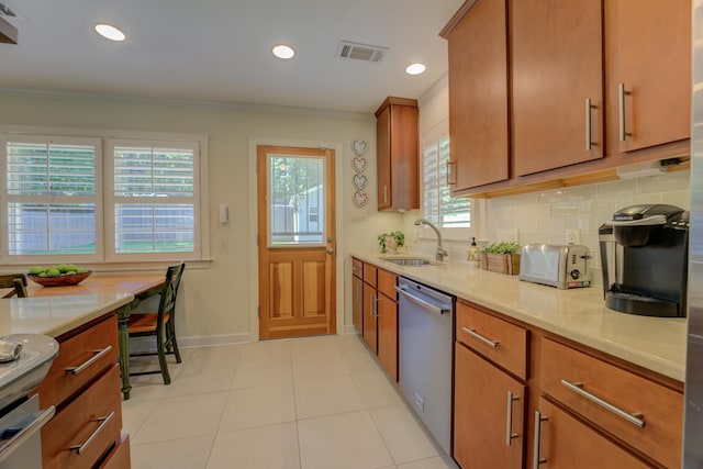 kitchen with dishwasher, ornamental molding, plenty of natural light, and sink