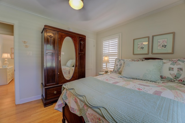 bedroom with light hardwood / wood-style flooring and crown molding