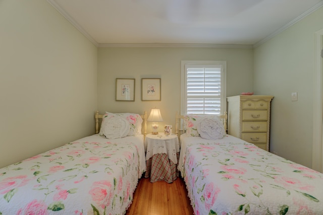 bedroom with light hardwood / wood-style floors and crown molding