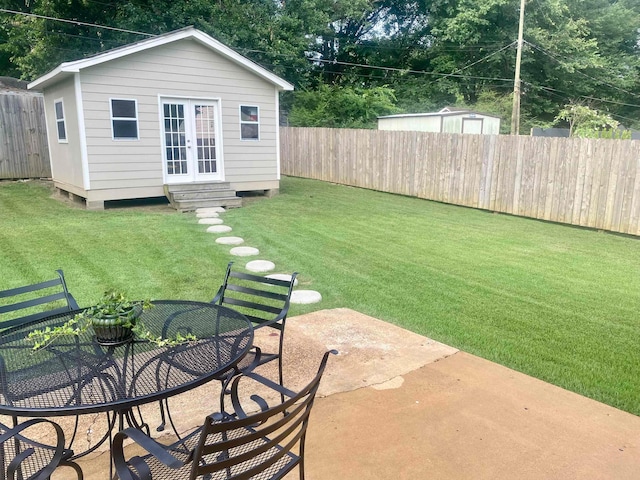 view of yard featuring an outbuilding and a patio