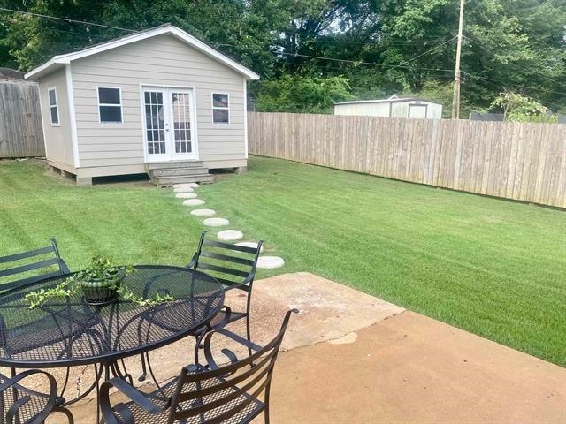 view of yard featuring a patio area and an outbuilding