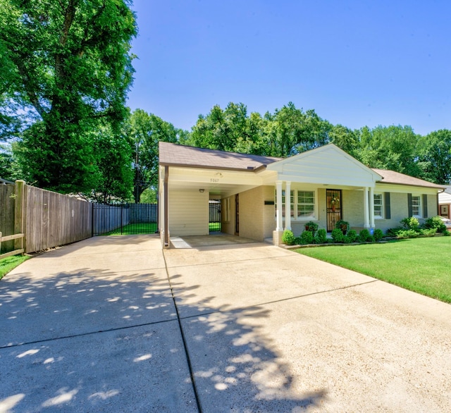 view of front facade with a carport, a porch, and a front yard