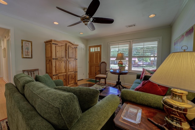 living room with ceiling fan, wood-type flooring, and ornamental molding