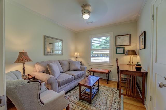 living room with ceiling fan, light hardwood / wood-style floors, and crown molding