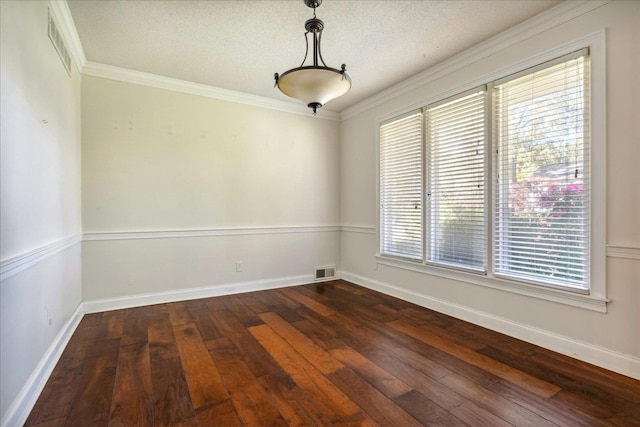 spare room with dark hardwood / wood-style flooring, a healthy amount of sunlight, a textured ceiling, and ornamental molding