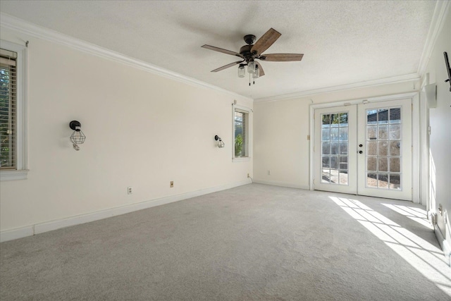 unfurnished room with light carpet, french doors, crown molding, and a textured ceiling