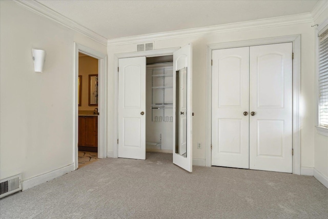 unfurnished bedroom featuring ornamental molding, light carpet, and a closet