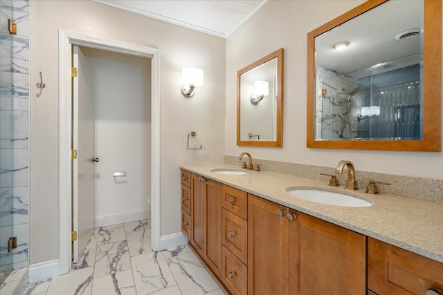 bathroom with a textured ceiling, vanity, and an enclosed shower