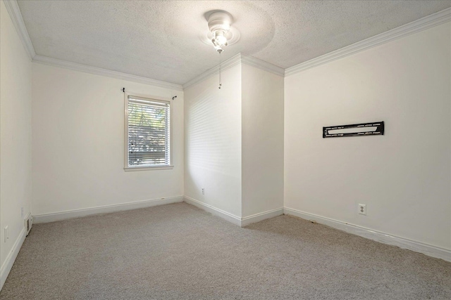 carpeted empty room with ornamental molding and a textured ceiling