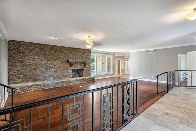 interior space with light hardwood / wood-style flooring, a textured ceiling, and ornamental molding