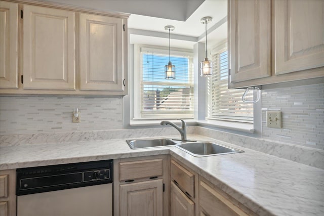 kitchen featuring dishwasher, light brown cabinets, sink, hanging light fixtures, and tasteful backsplash